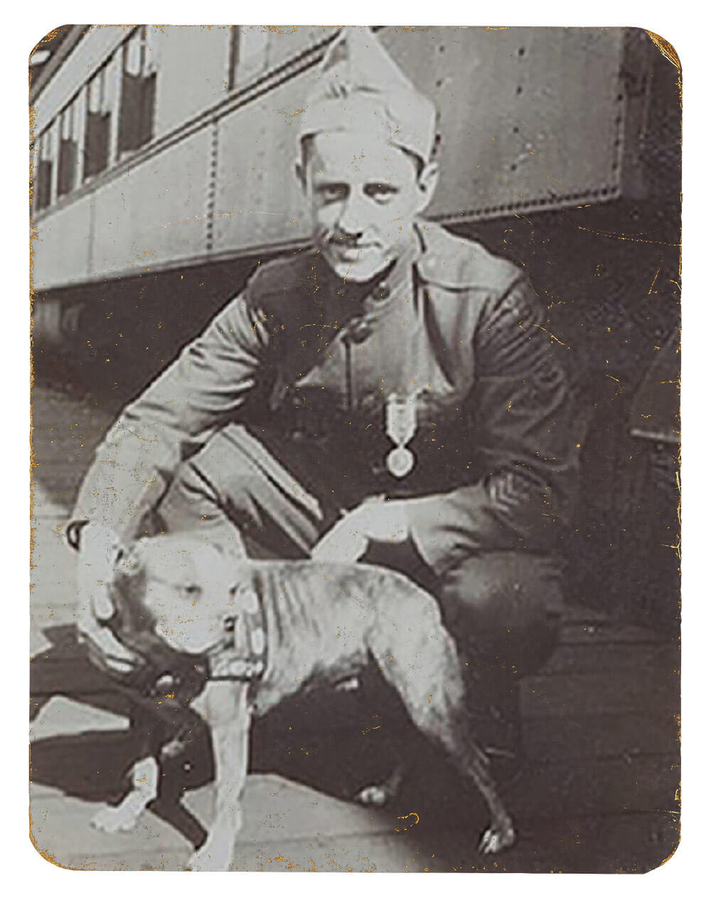 Robert Conroy kneeling beside Sergeant Stubby